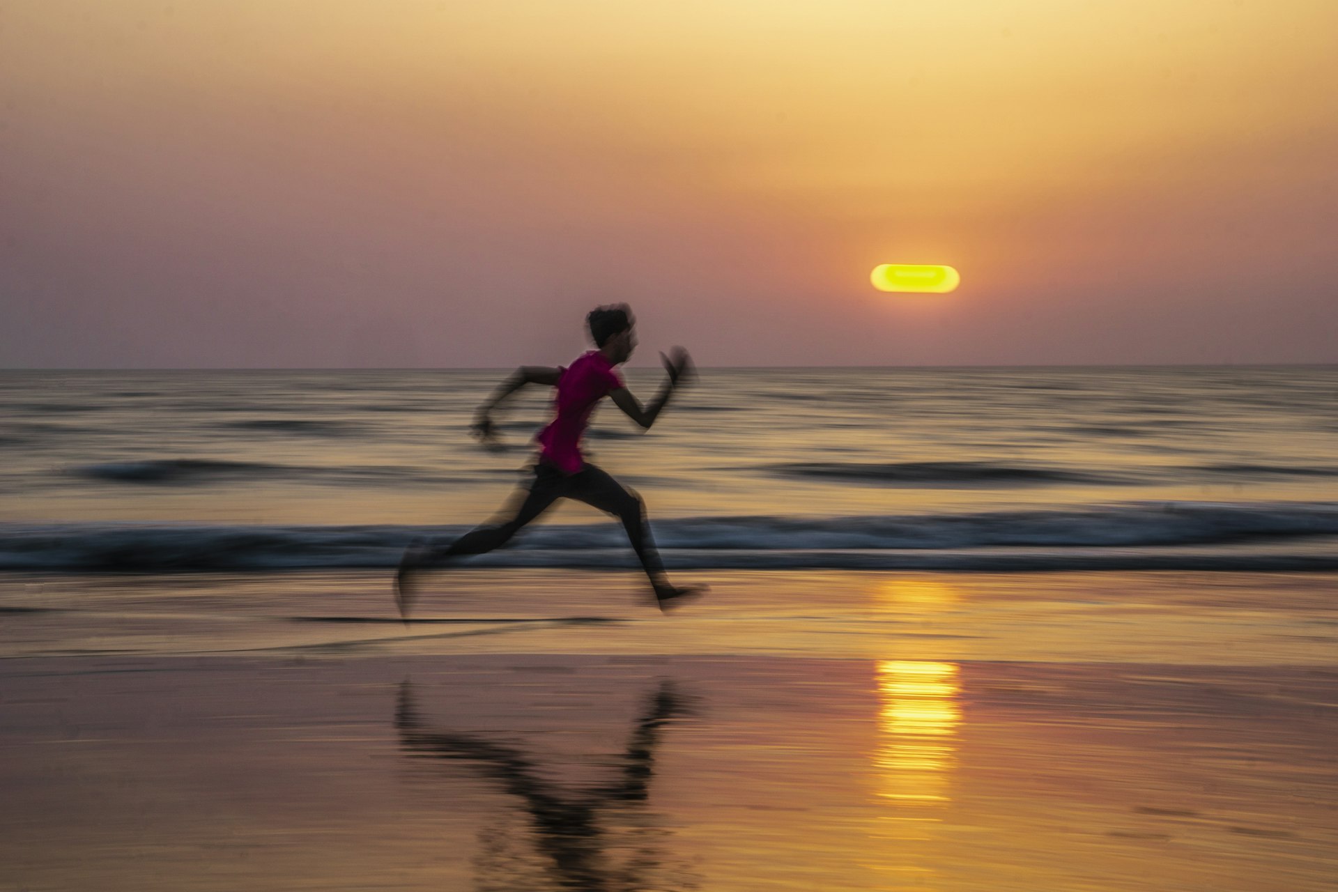 Runner on the beach at sunset — daily overcoming